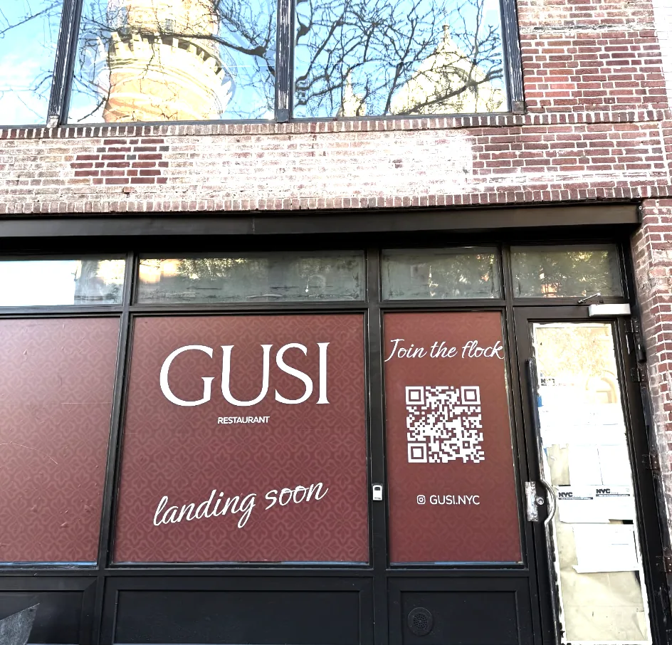 GUSI Restaurant window display reading "GUSI Restaurant — Landing Soon" with a QR code at 432 Sixth Avenue in Greenwich Village, New York City