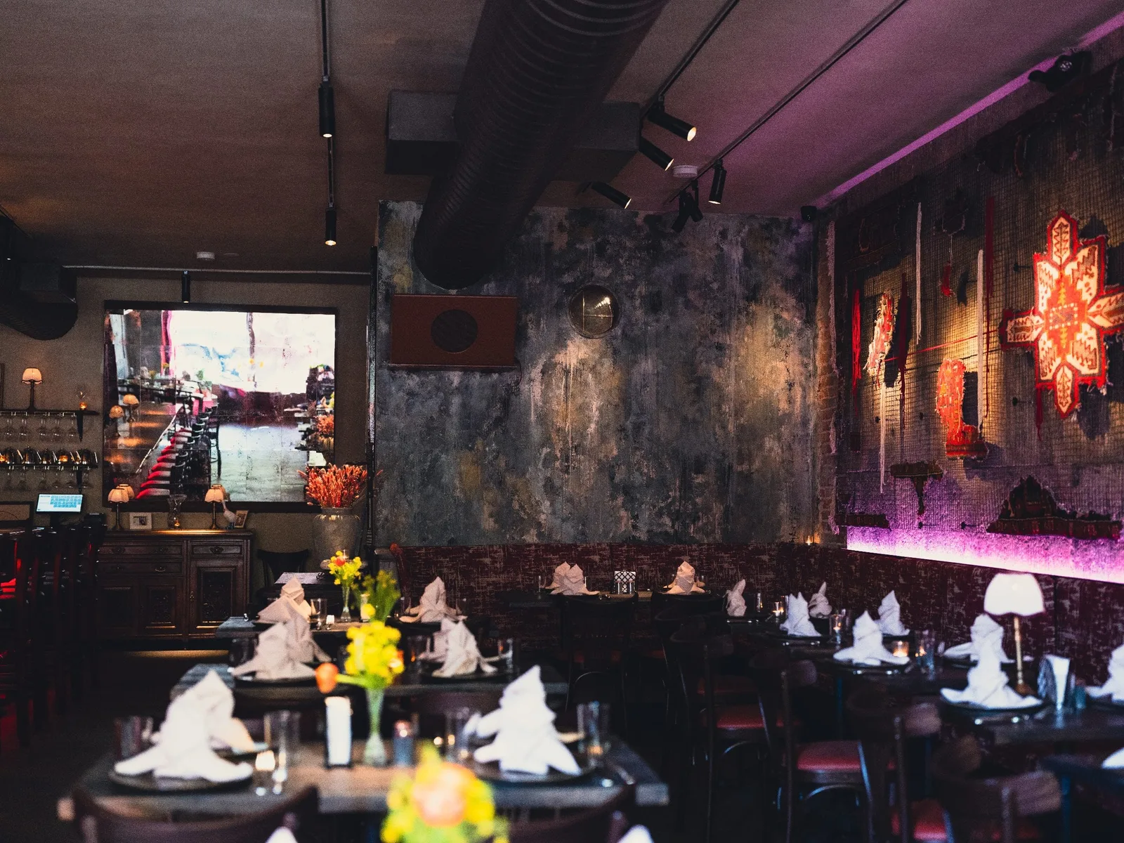 GUSI first-floor dining room detail — original art on hand-troweled walls in a modern Eastern European tavern bar in Greenwich Village, NYC