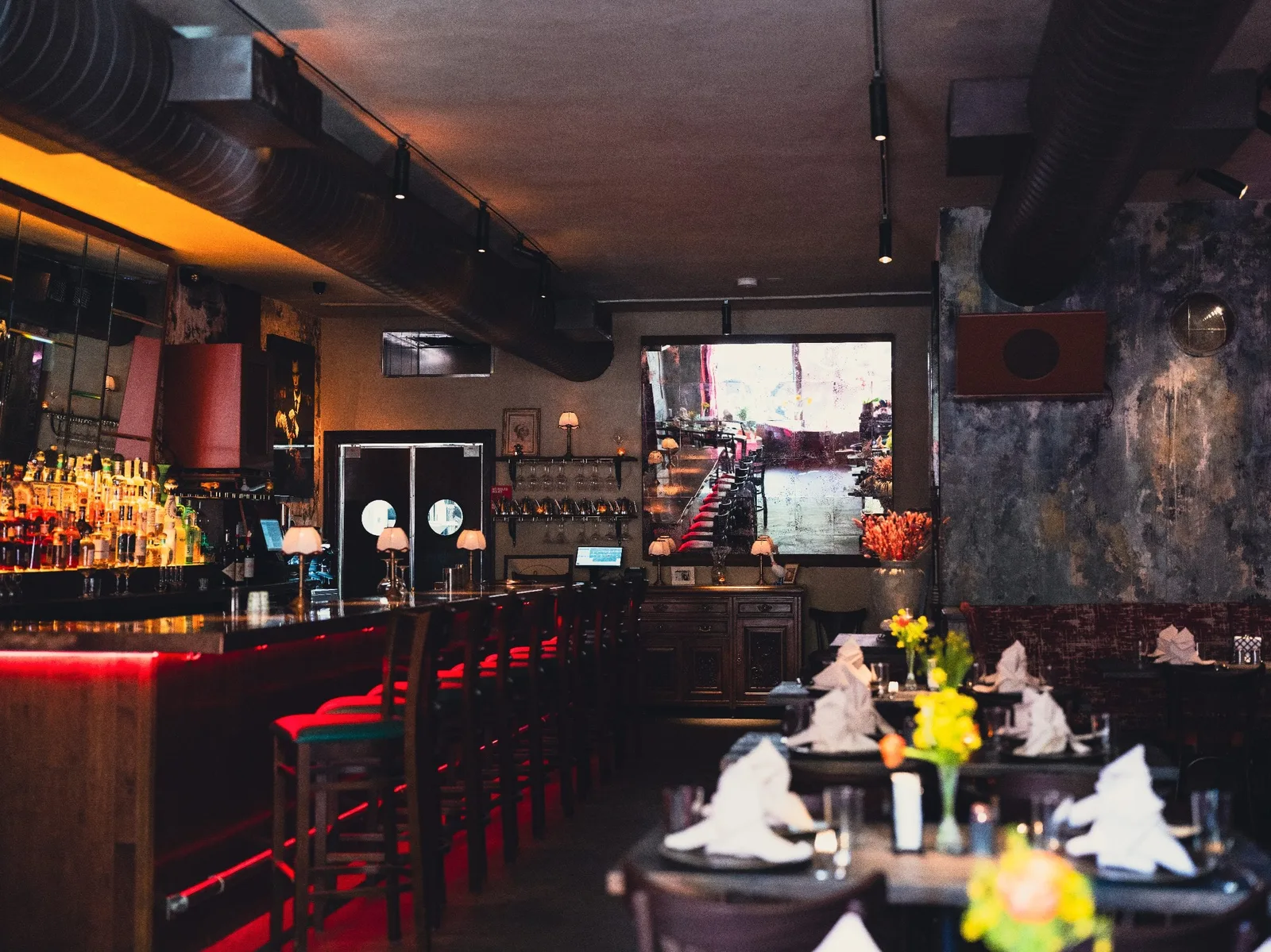 Wide view of GUSI's first-floor dining and bar room in Greenwich Village, New York — candlelit Eastern European tavern atmosphere at 432 Sixth Avenue
